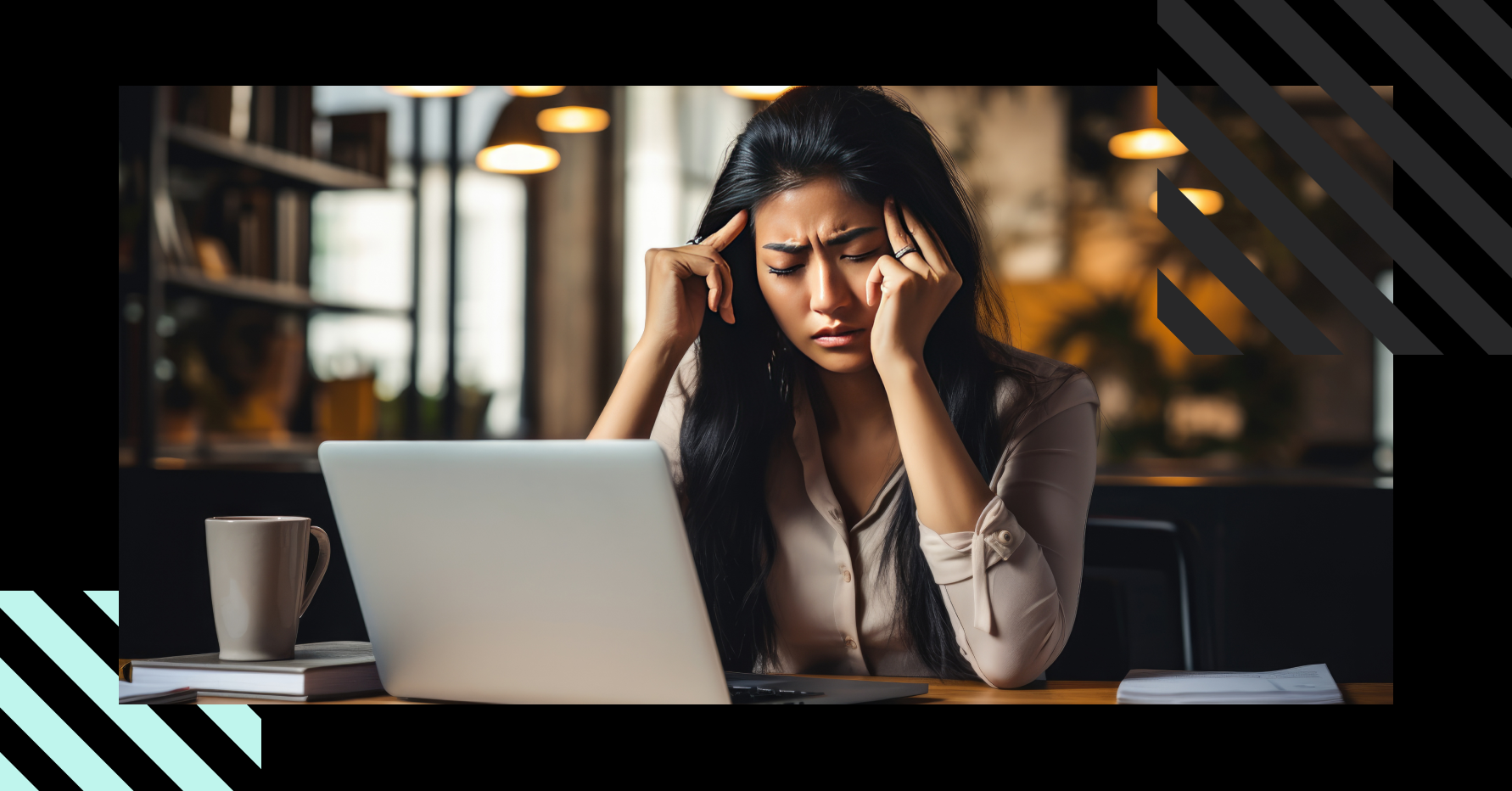 Photograph of a tired revenue professional massaging their temples in front of a laptop